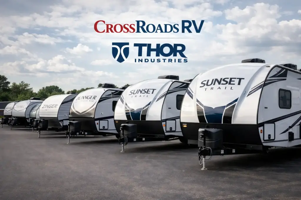 CrossRoads RV travel trailers lined up at a dealership under Thor Industries ownership