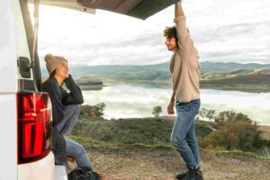 side-view-couple-sitting-rv-while-road-trip